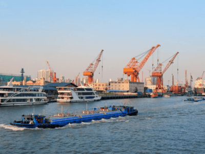 Blog 1 Porto com barcos e guindastes.